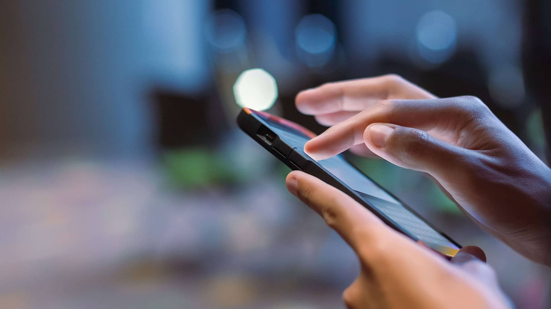 close up of hand touching mobile phone