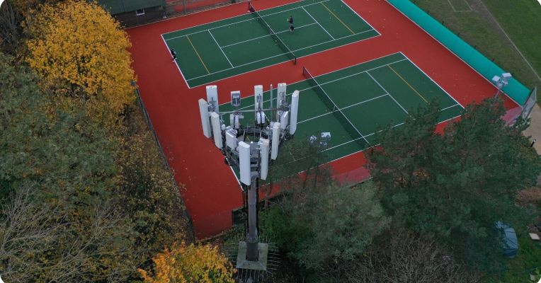 Telecoms tower next to a tennis court