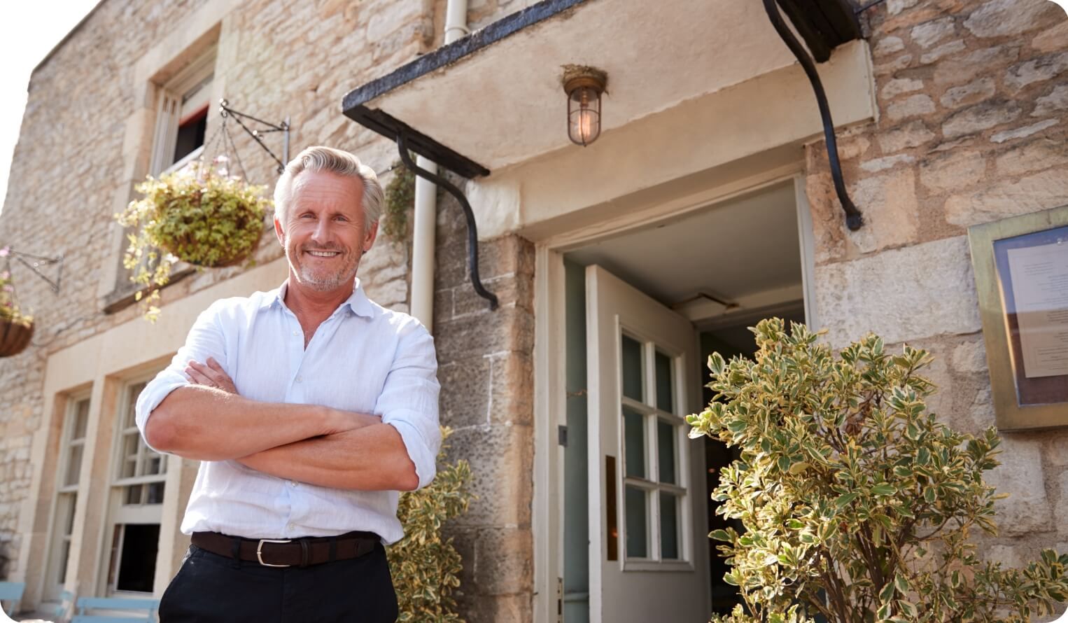 Man standing outside of a house and smiling