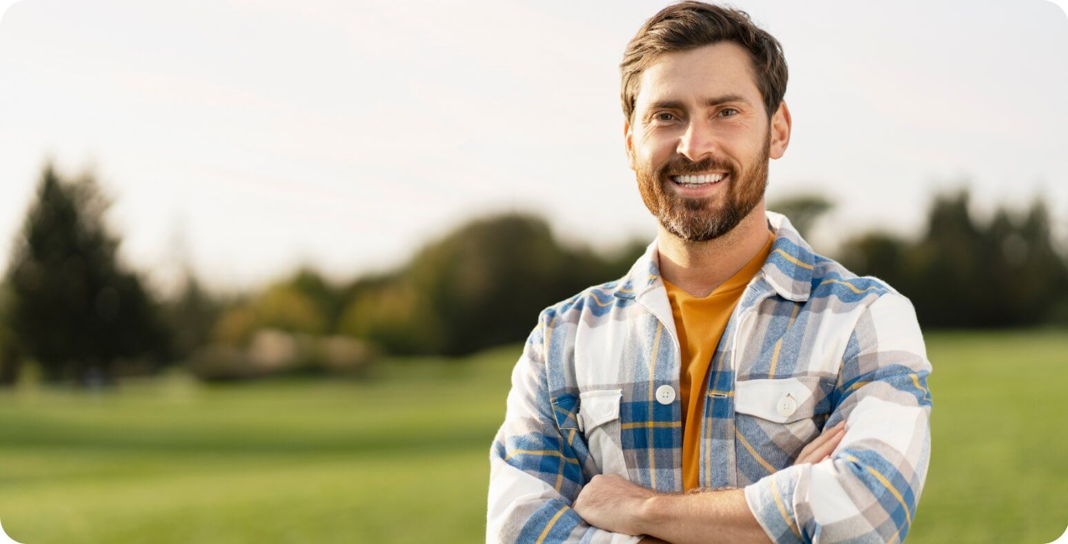 Man standing and smiling at camera