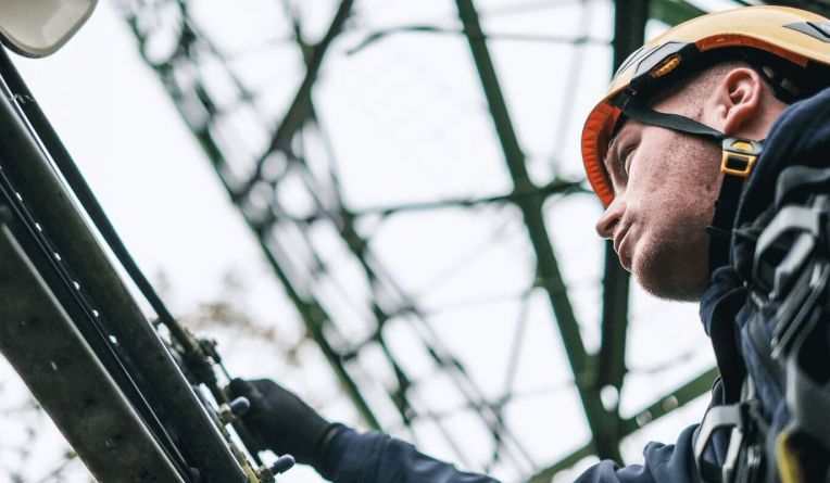 Man fixing a telecoms tower