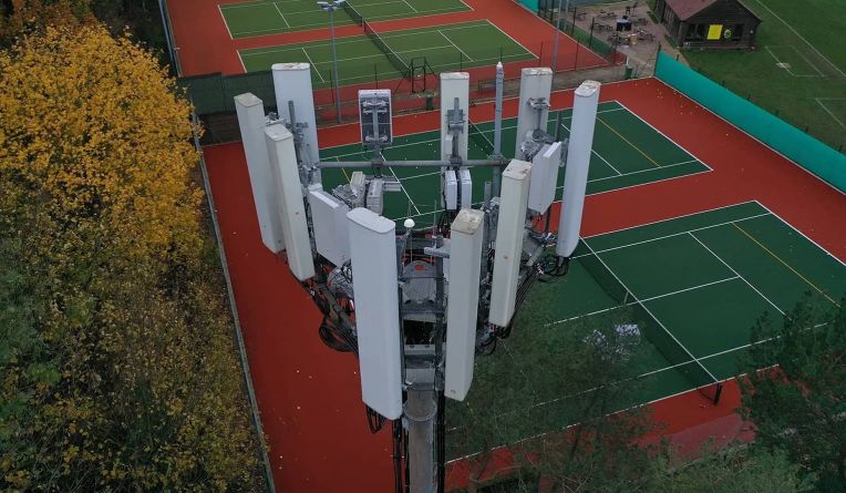 Telecoms tower next to a tennis court