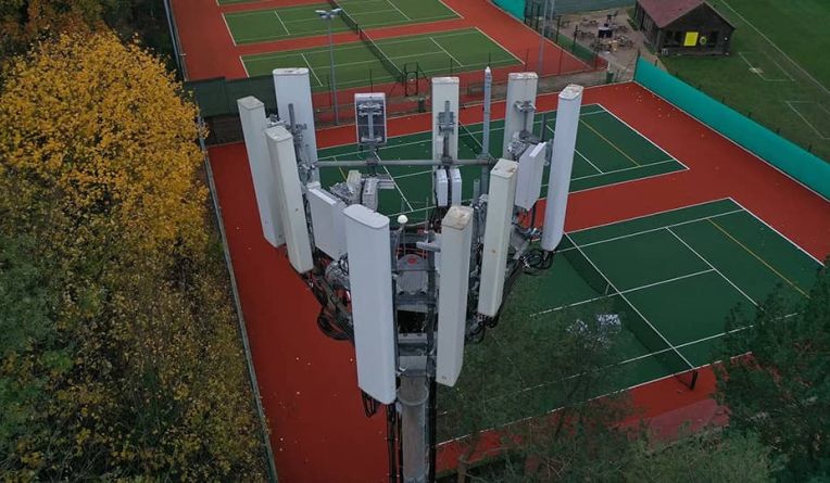 Telecoms tower next to a tennis court