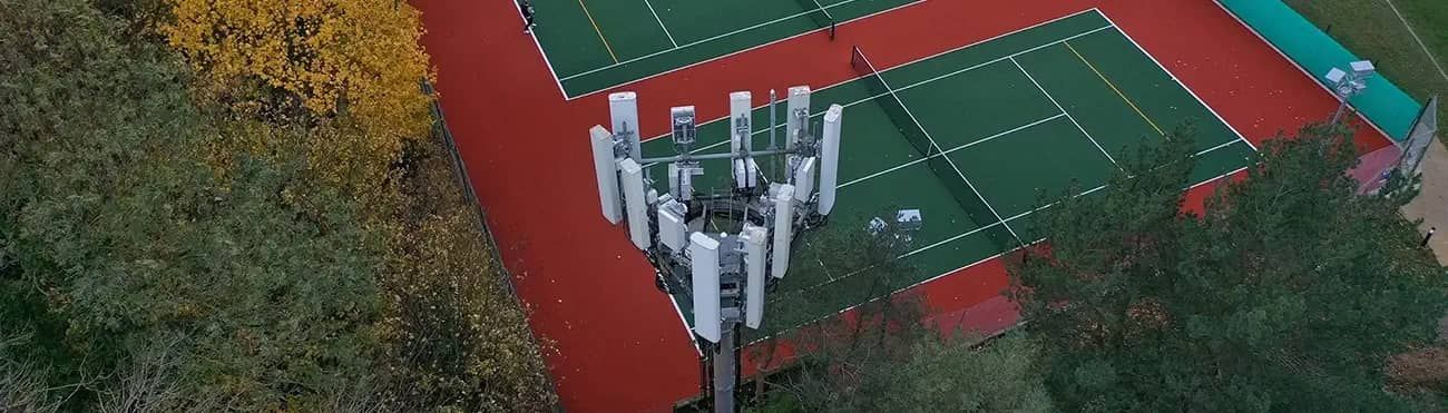 Telecoms tower next to a tennis court