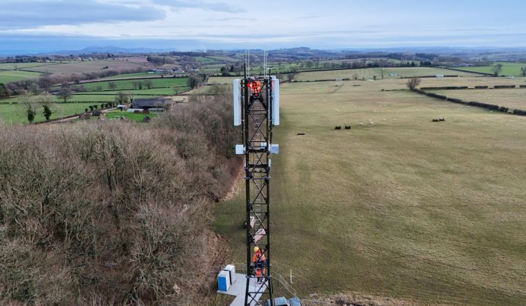 Man standing on a balcony looking at view
